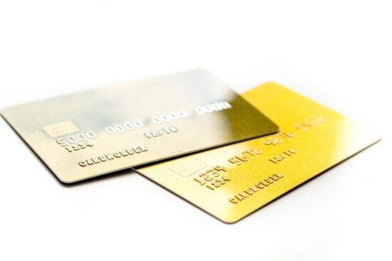 Two credit cards sitting on a white background