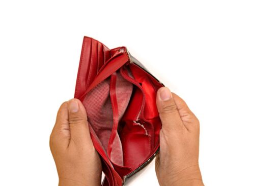 Hands holding up an empty red wallet