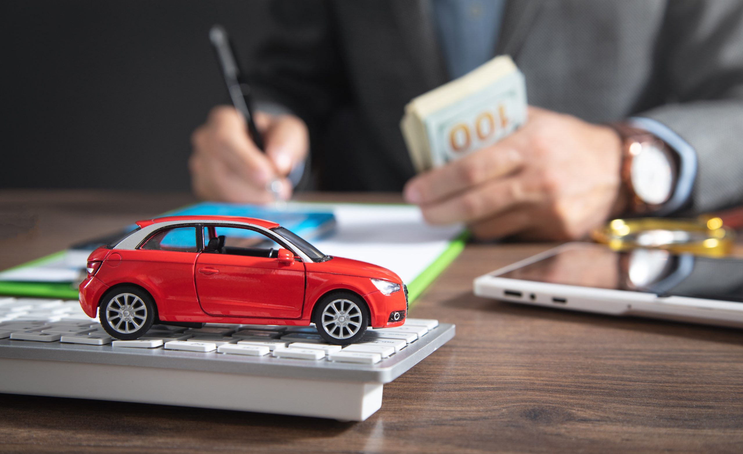 Insurance agent signs a document. Car insurance