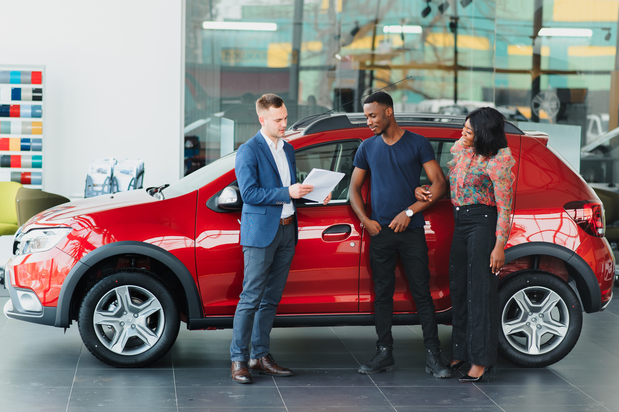 young african american couple buying new car at dealership